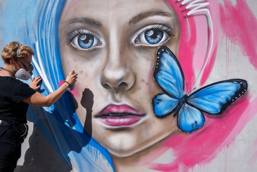 artist painting graffiti during UPFEST